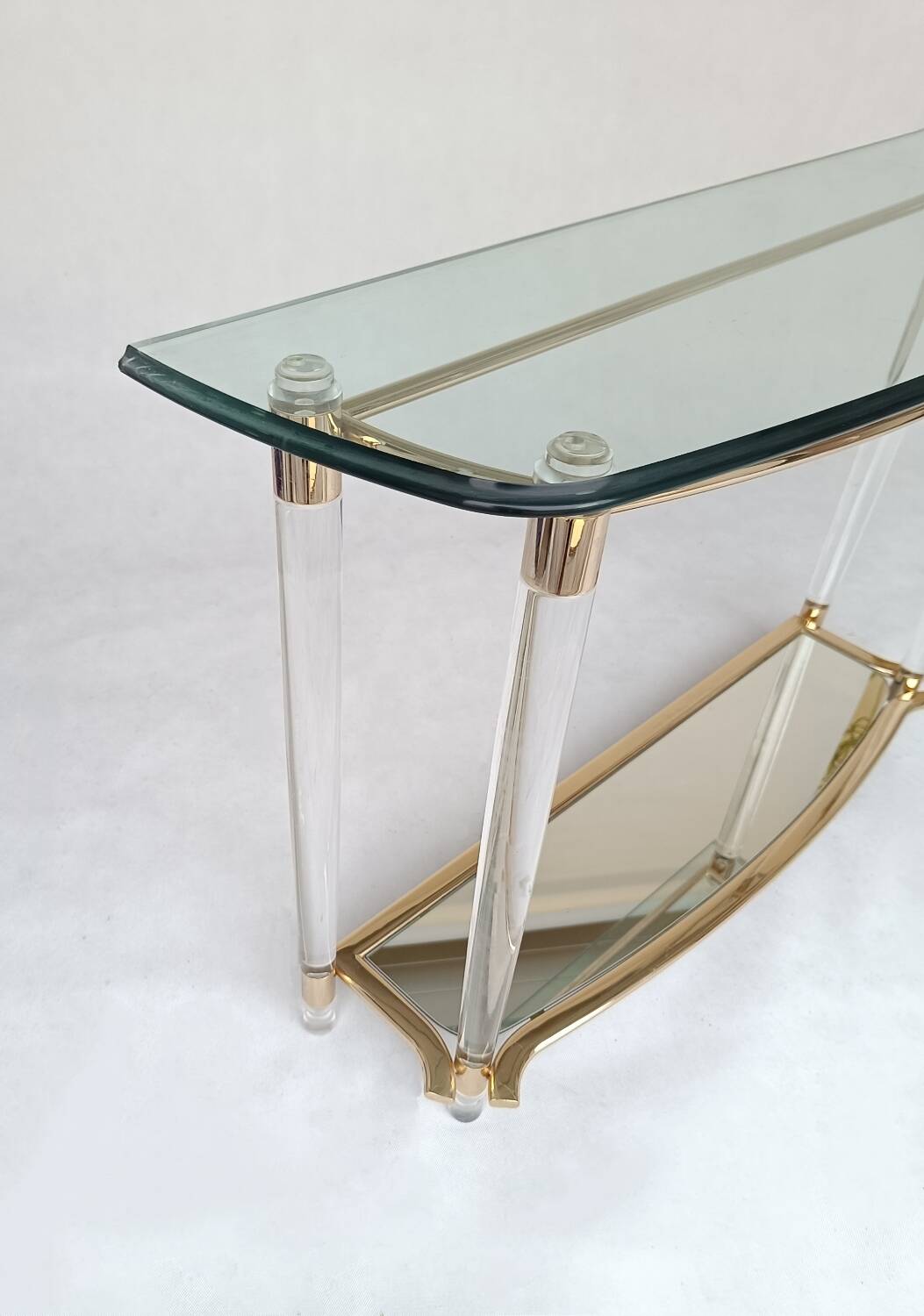 Hollywood Regency console table in lucite, glass and gold metal. 1980s