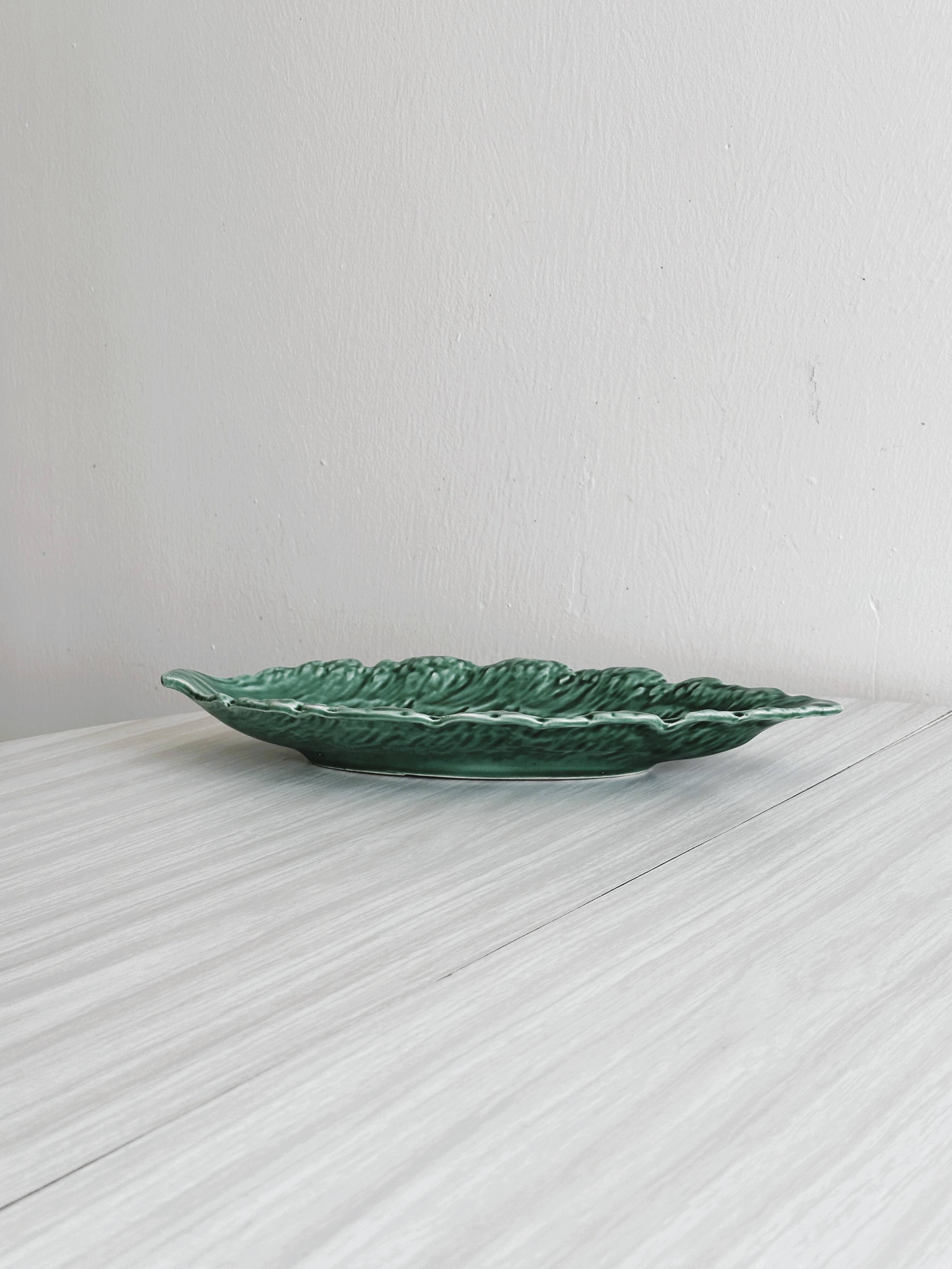 Green earthenware dish in the shape of a leaf