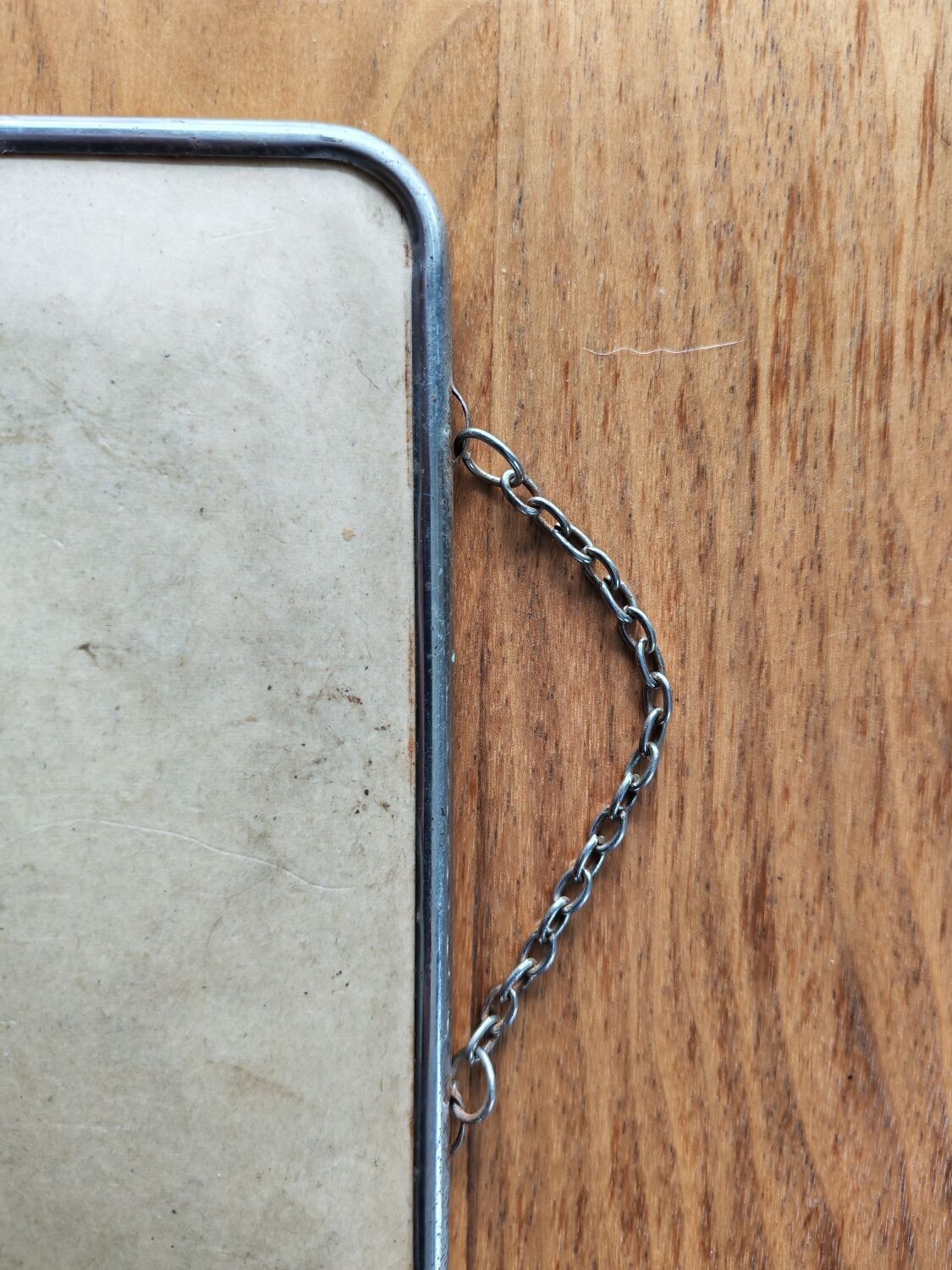 Vintage barber mirror with chain.
