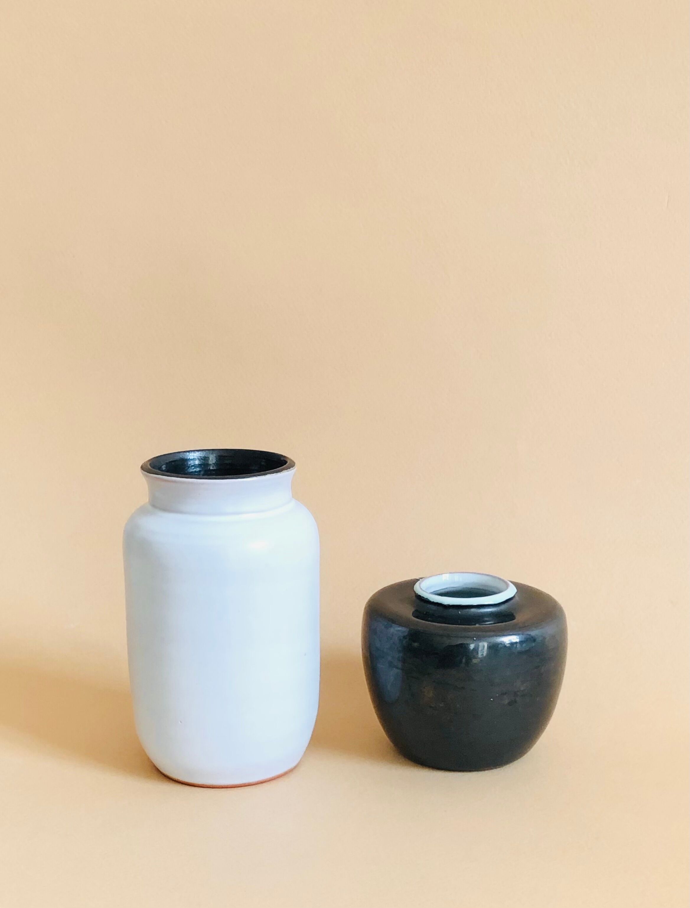 Duo of small black and white ceramic vases