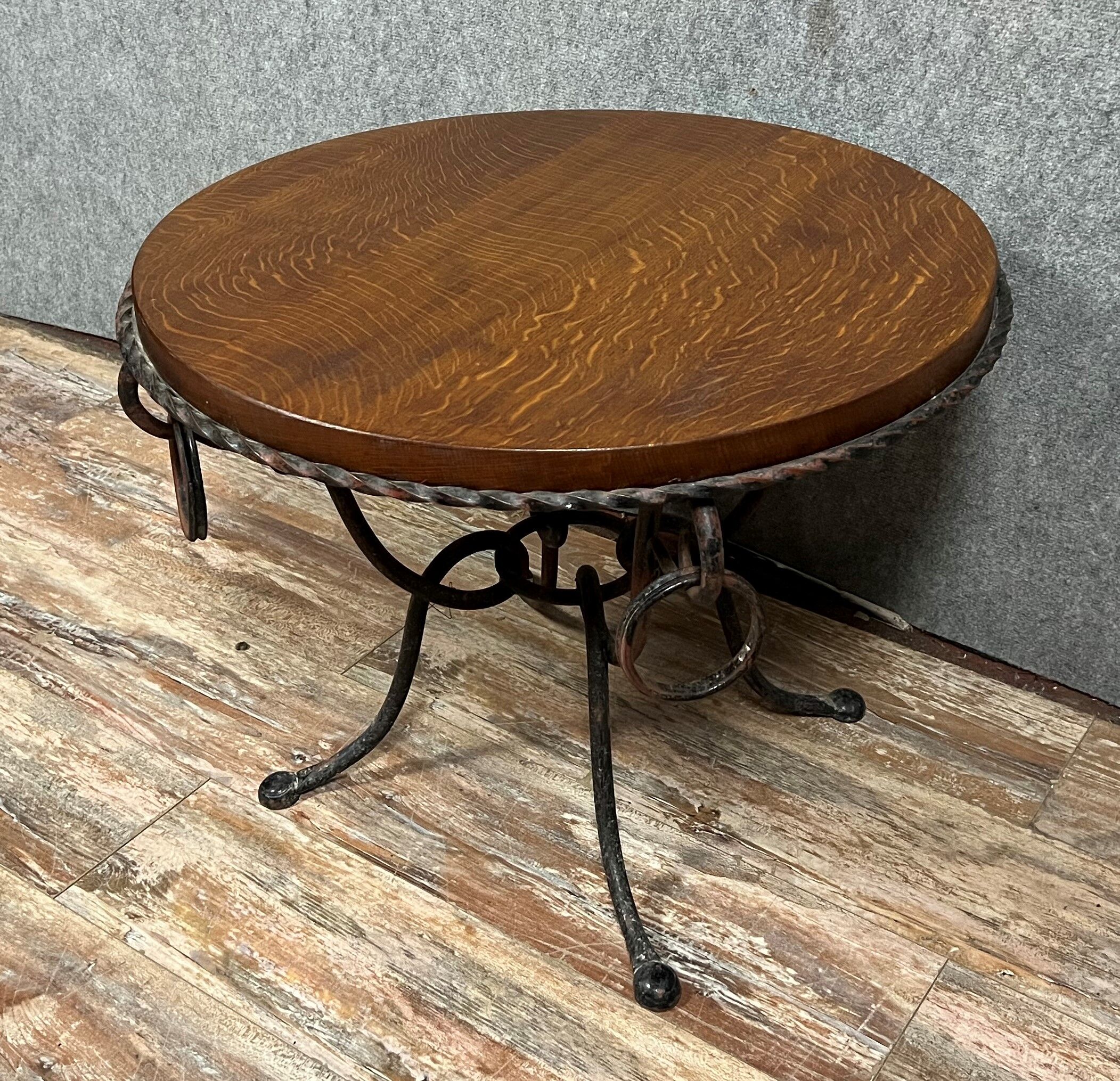 Hammered iron coffee table with circular wooden top