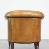 Comfortable, cozy, warm colored sheepskin club chair finished with decorative nails
