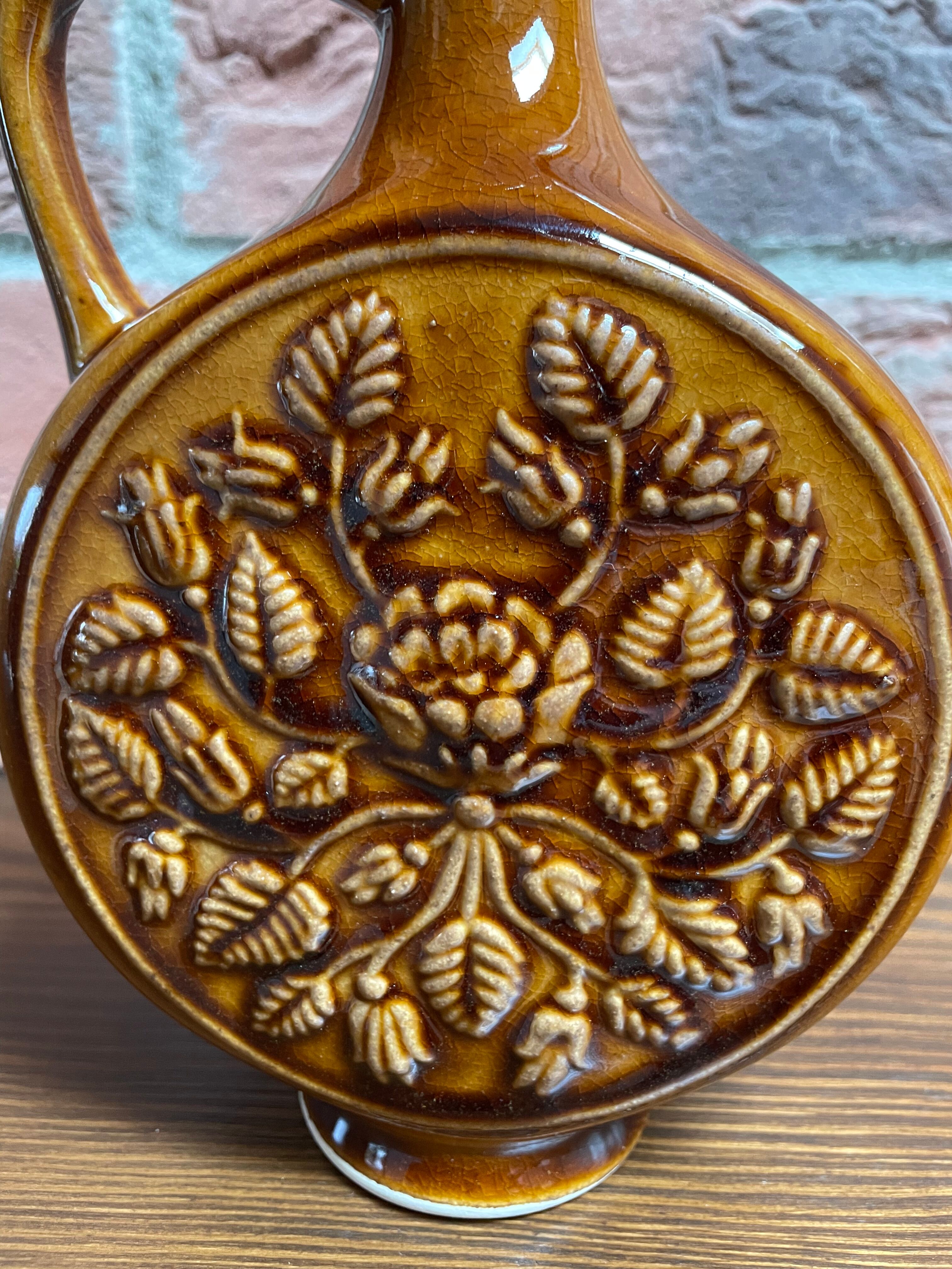 German round vase with floral motif, ornamental brown ceramic jug with handle