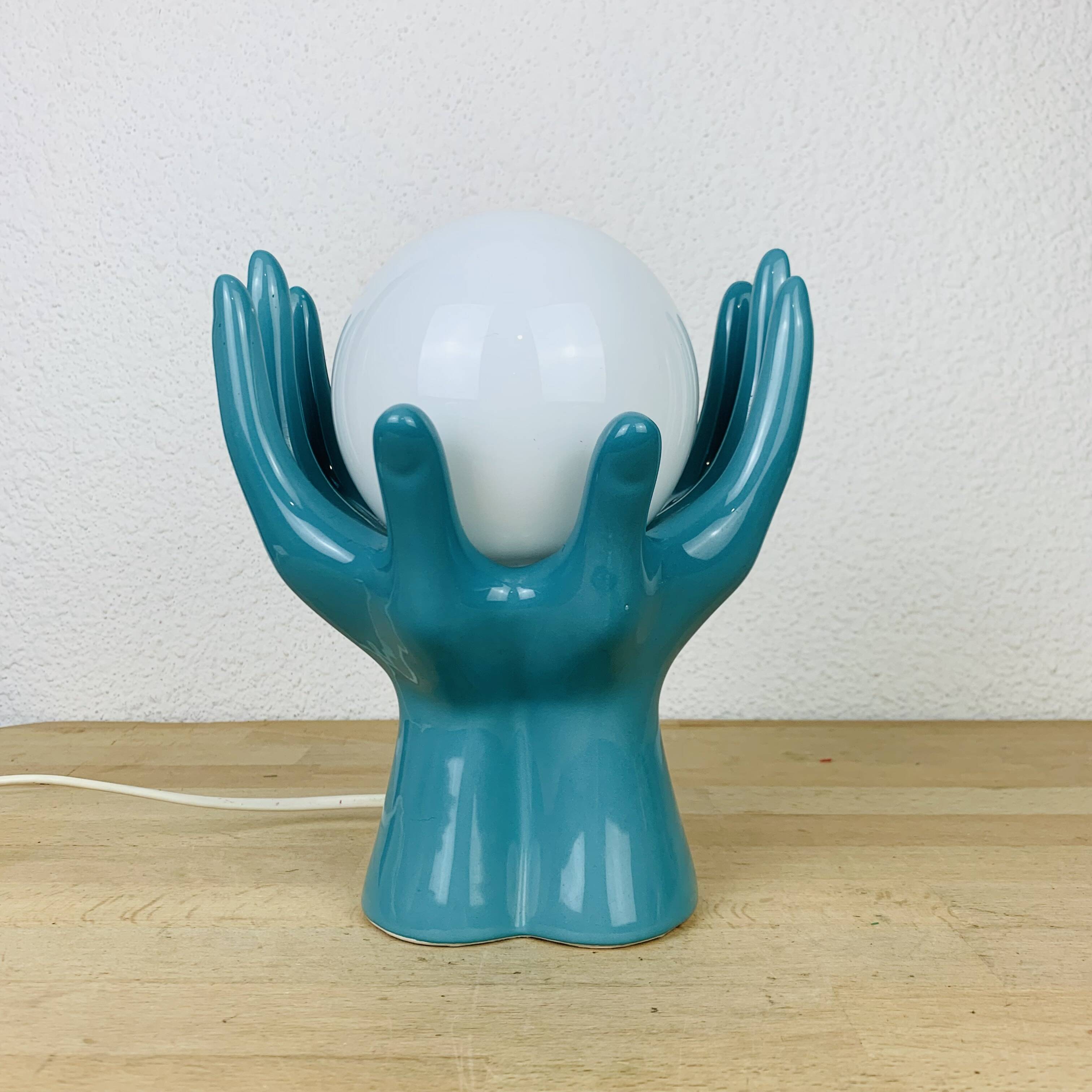 Blue ceramic hands lamp and glass globe