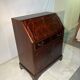 Antique mahogany secretary, upholstered flap and interior storage