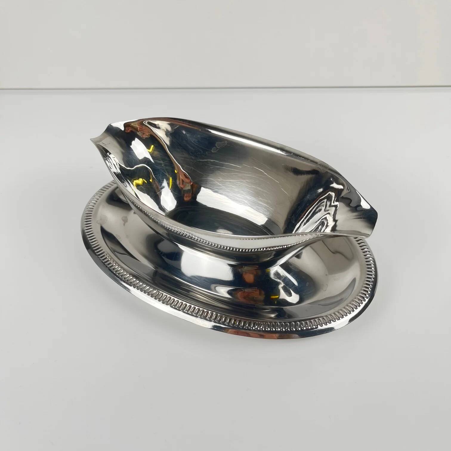 Metal sauceboat in Empire style, silver colour.