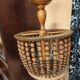 Vintage wooden turned cage chandelier with beads from the 1960s.
