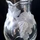 Large water jug with embossed fruit decoration in frosted glass