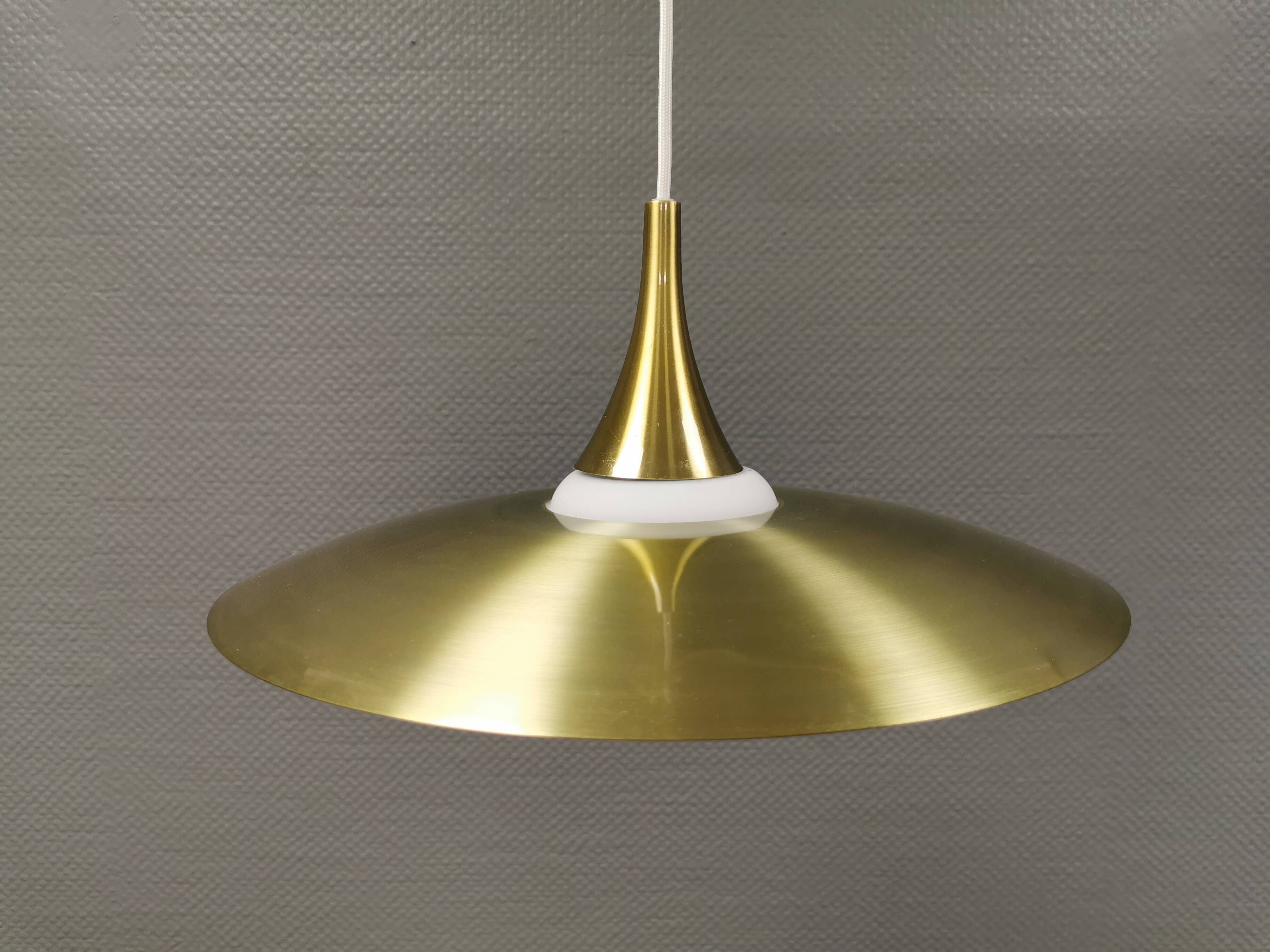 Hanging lamp, from the 1970s in matte white glass and brass colored metal.