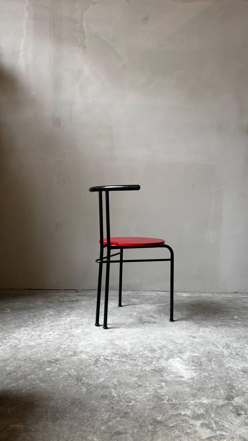 Set of 4 vintage black metal chairs with red lacquered seats.