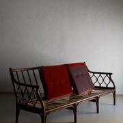 Dark rattan 3-seater sofa with red velour cushions | 1980s