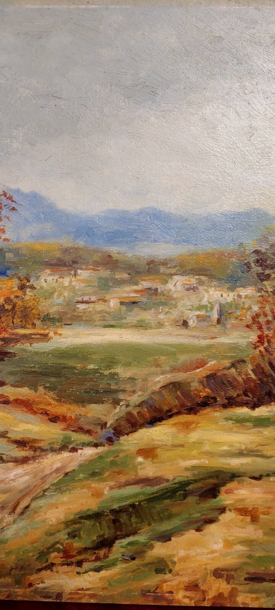 Oil painting on panel of a rural landscape, signed.