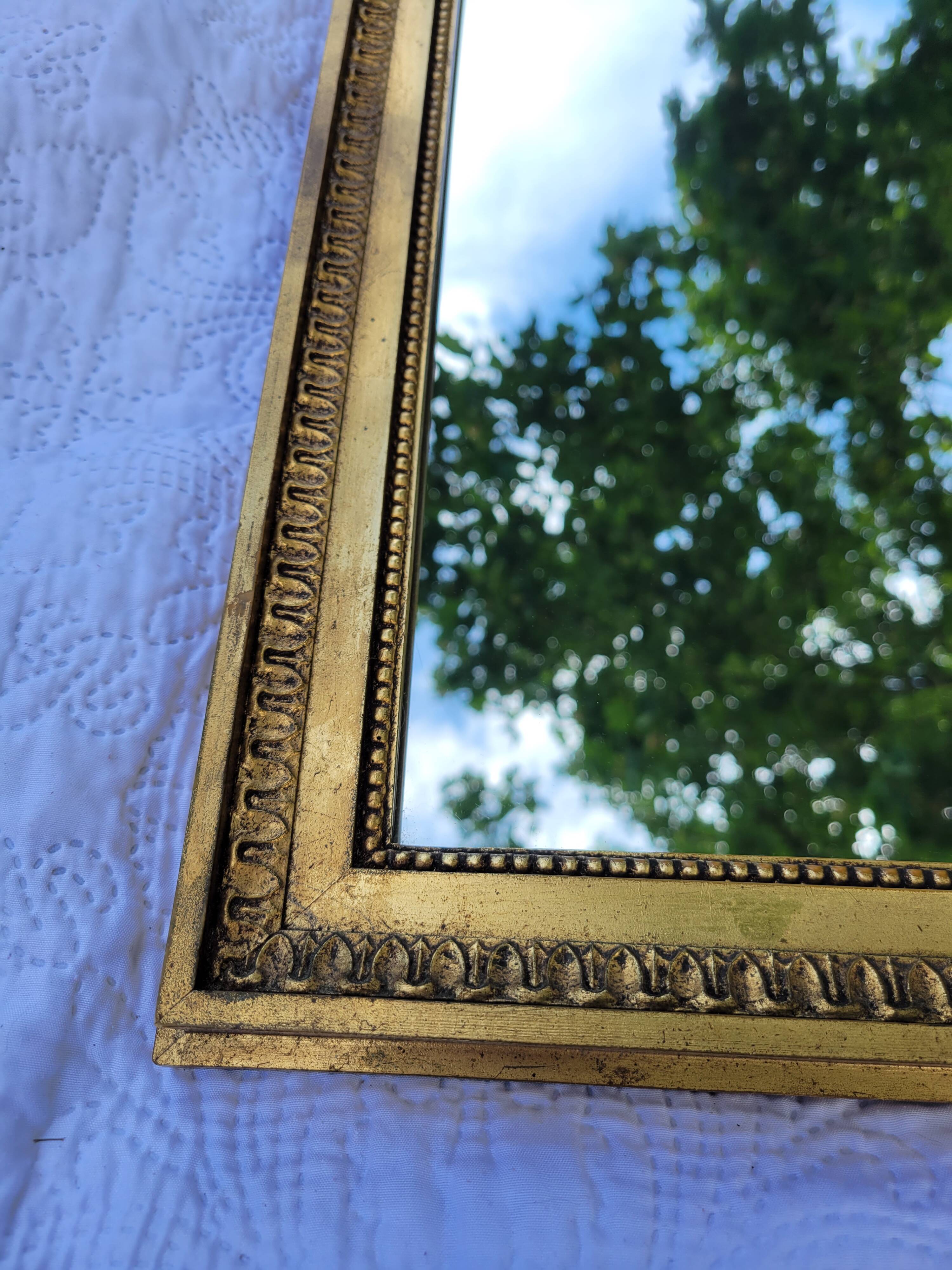 Old mirror in gilded wood