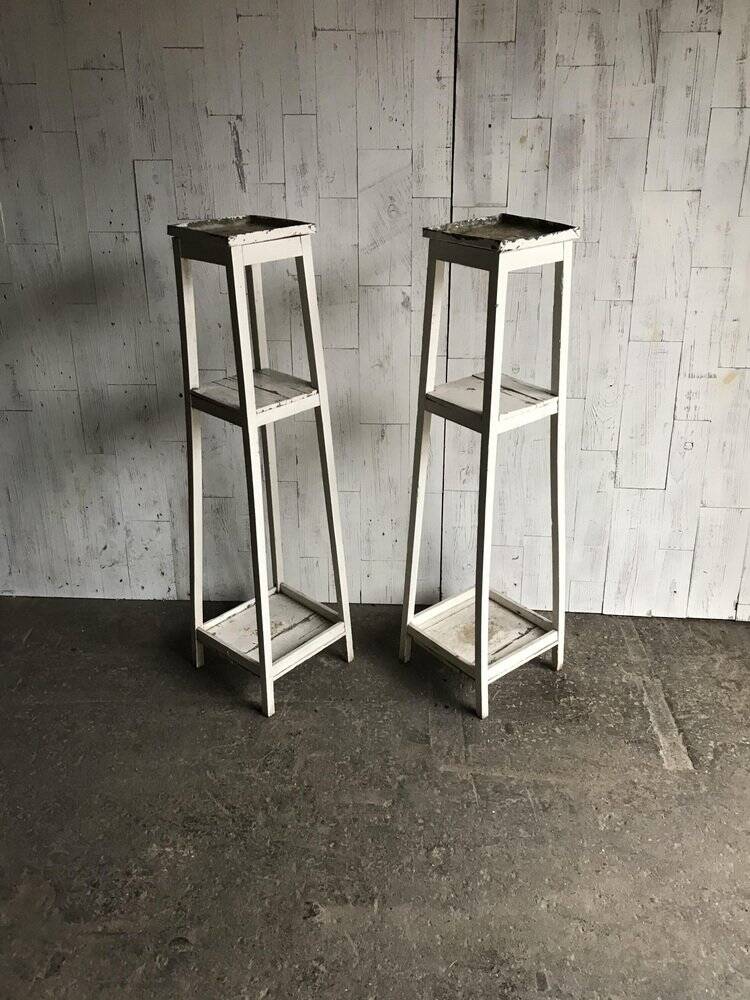 Two white vintage mid-20th century wooden plant stands, 3-tier shelves.