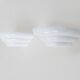 Pair of Art Deco style wall lights in white lacquered metal. 1980s