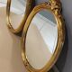 Paire de miroirs oval  doré vintage