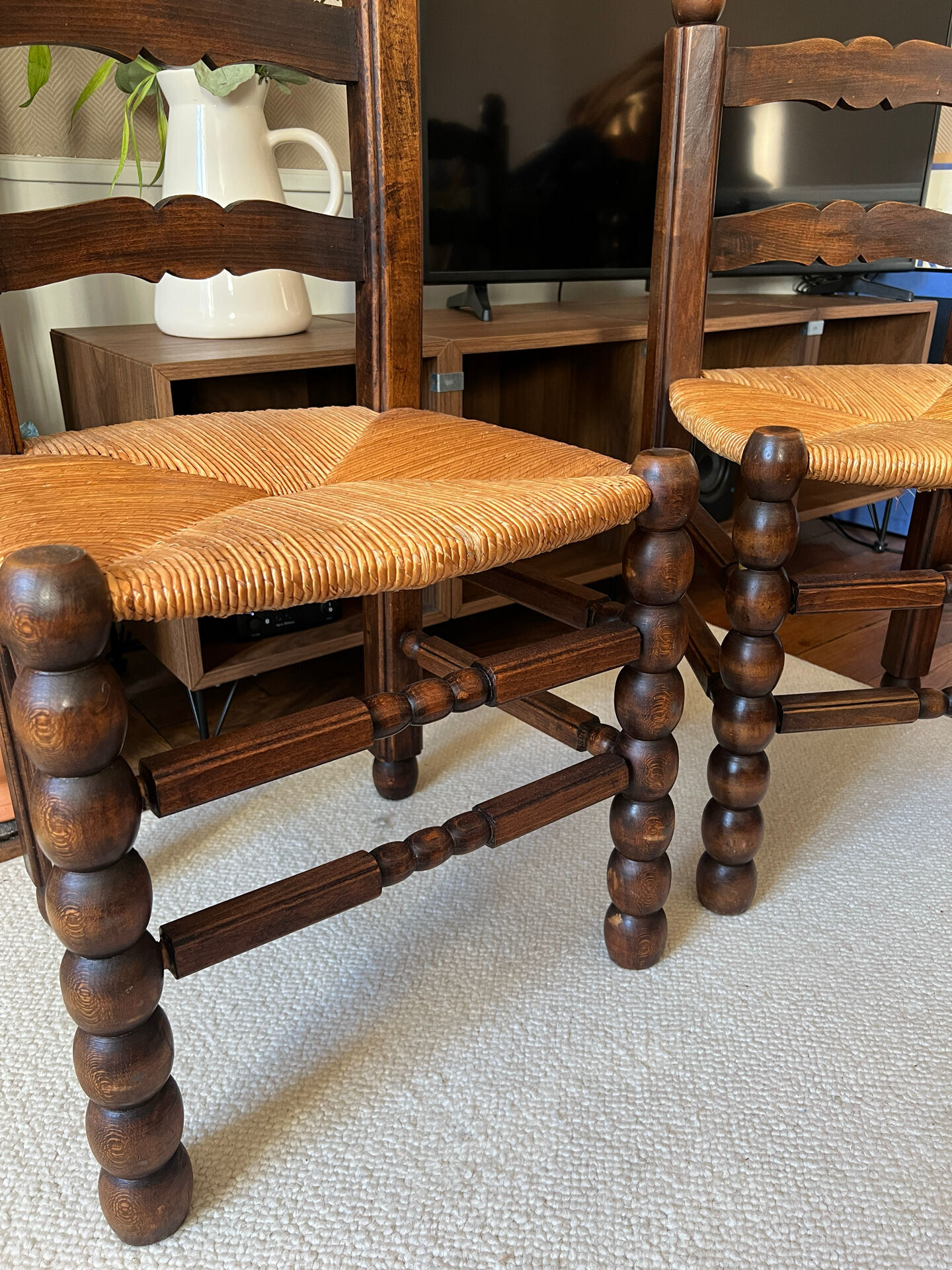 Pair of vintage armchairs with turned wood and woven rope seat.