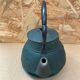 Old green cast iron Japanese teapot with flower decoration + vintage stand