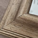 Beveled mirror under gold frame