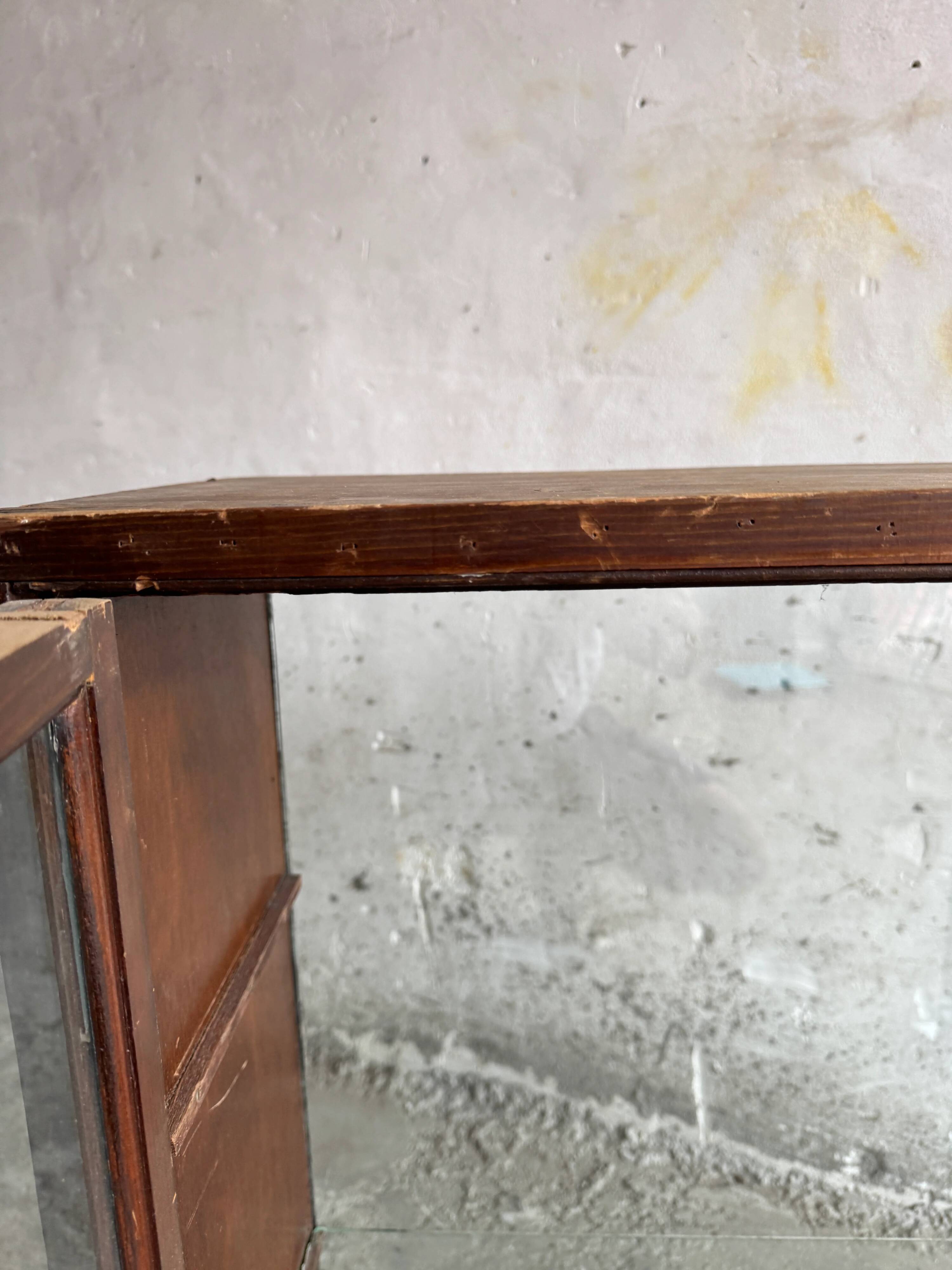 Dark-stained wood and glass vintage display cabinet — early 20th-century wall-mounted showcase