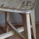 Old workshop stool in patinated solid wood