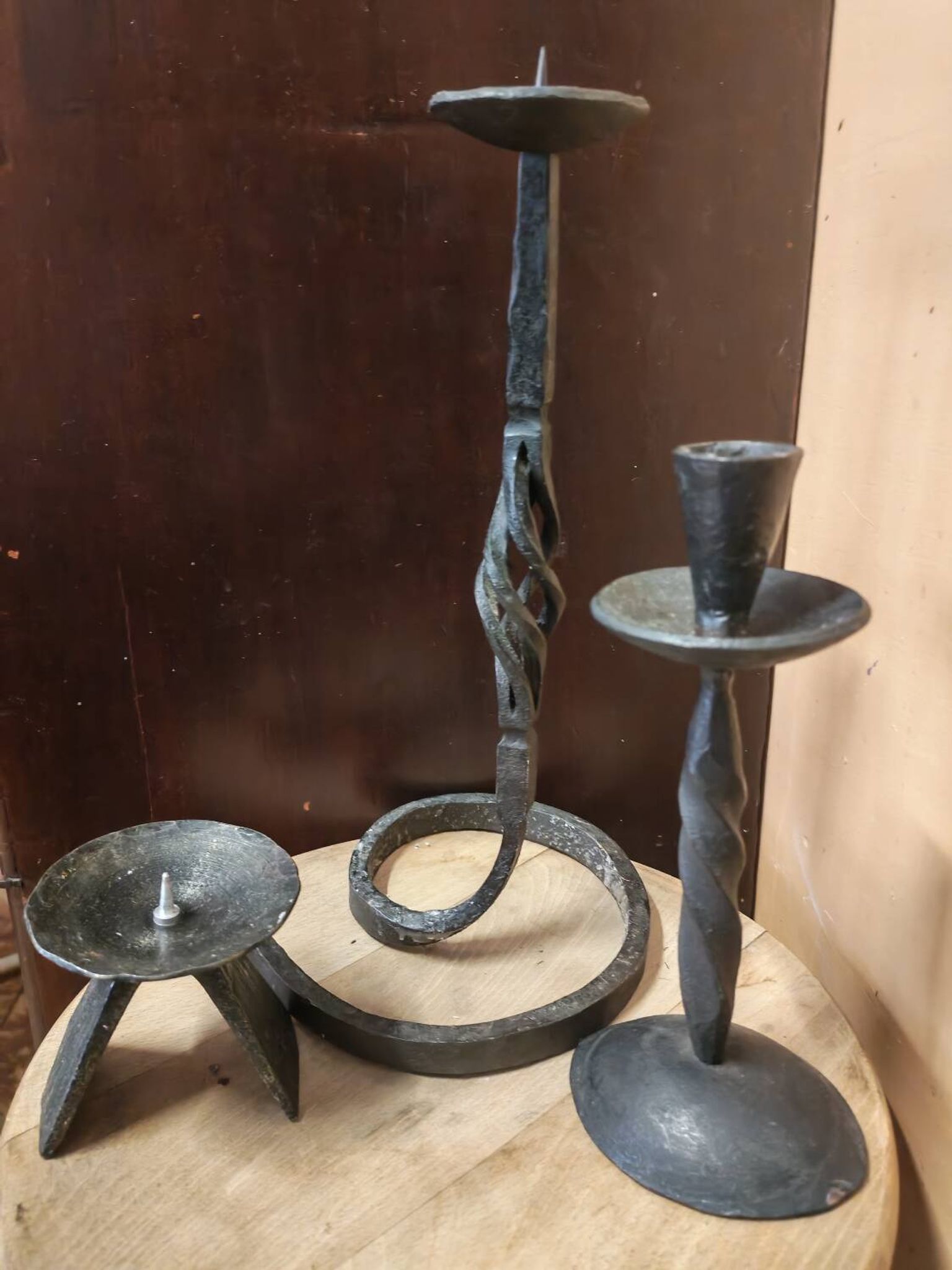 Set of 3 candlesticks and a candle holder in wrought iron.