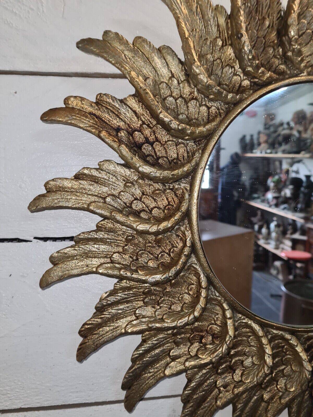 sun mirror with angel wings in golden patinated stucco