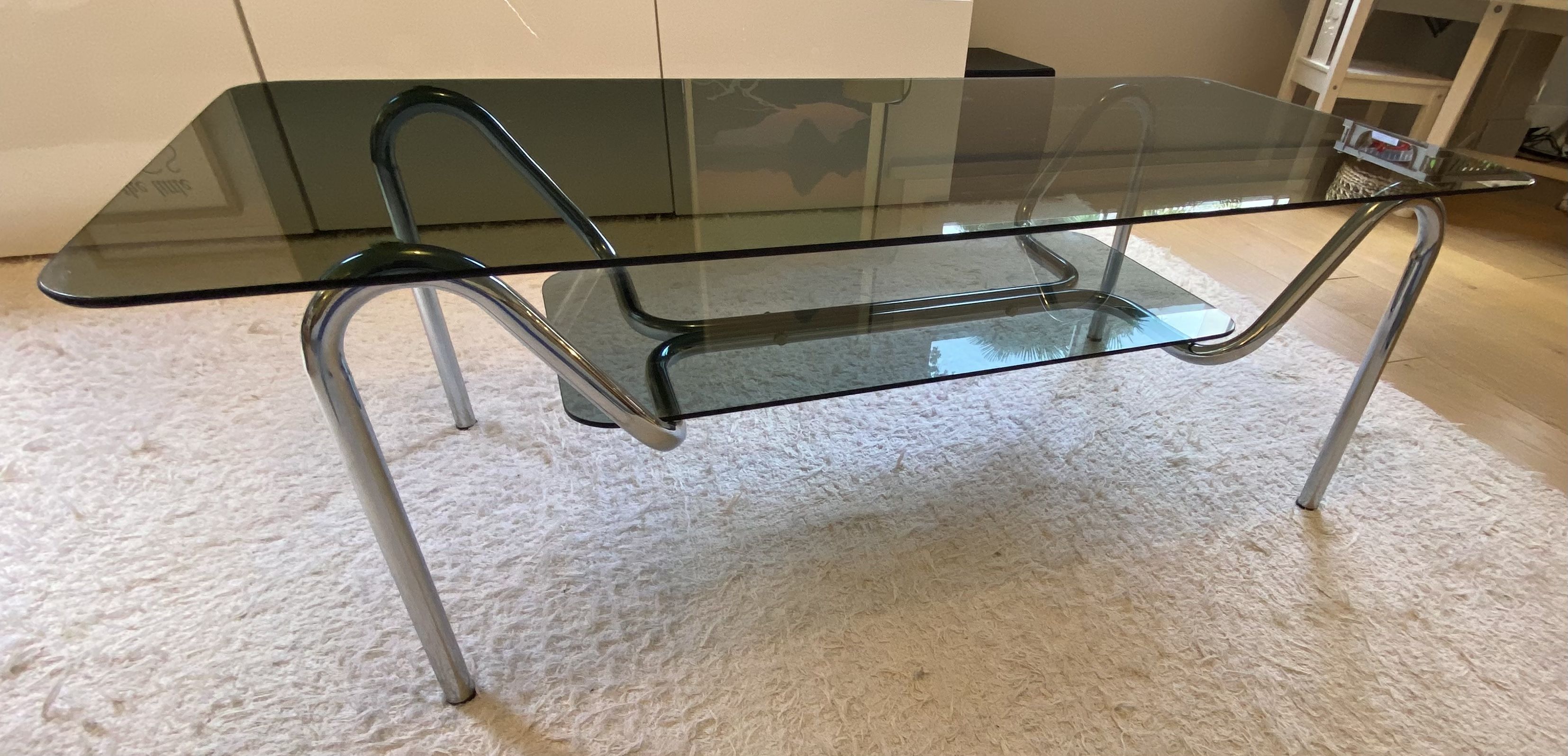Double top coffee table in smoked glass and tubular structure in chromed steel