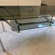 Double top coffee table in smoked glass and tubular structure in chromed steel