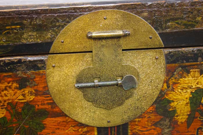 Brown and gold lacquered Chinese chest decorated with flowers circa 1900