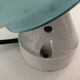 Wall light in ceramic with a light blue glass globe.
