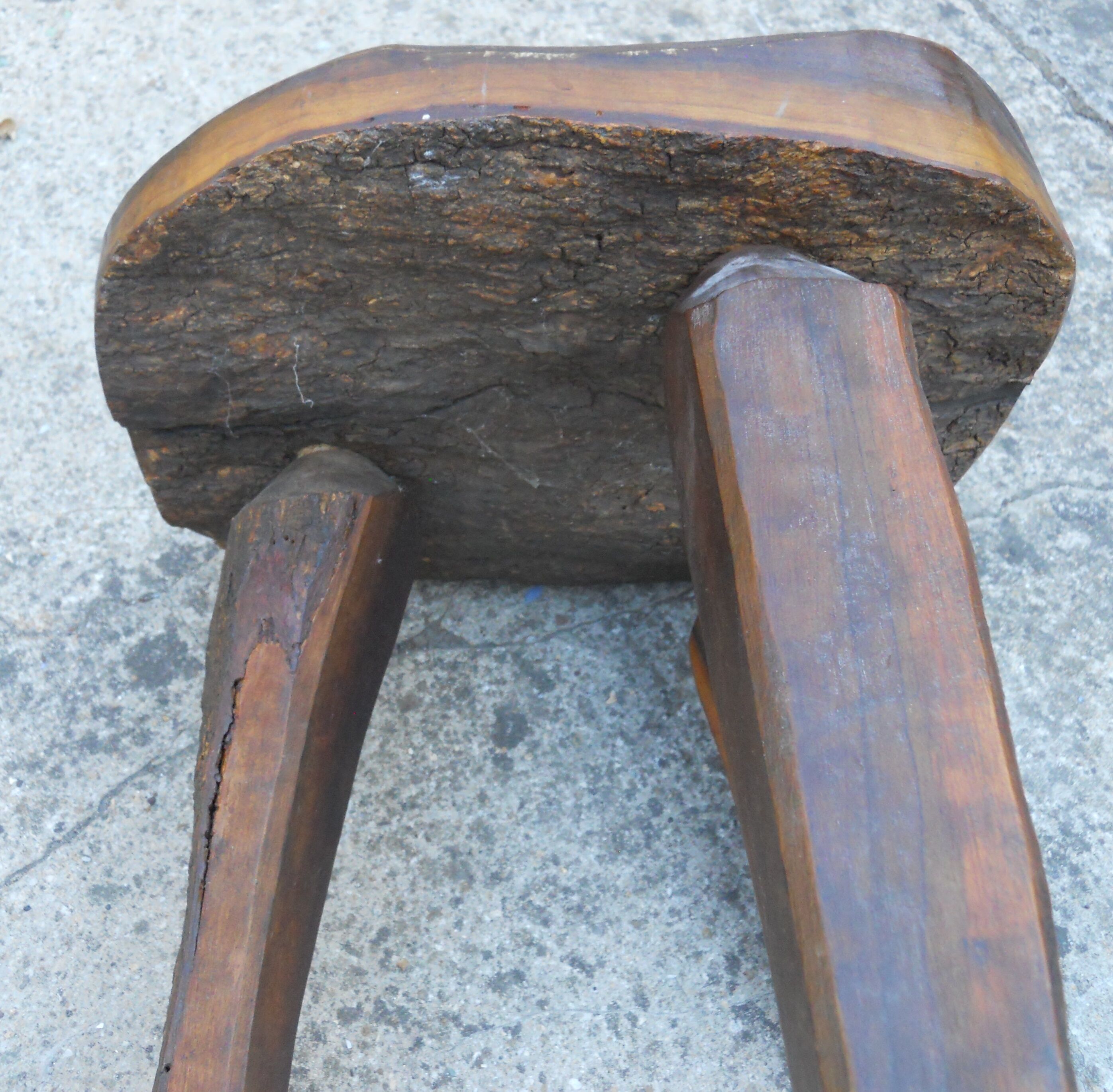 three-legged milking stool made of olive tree folk art