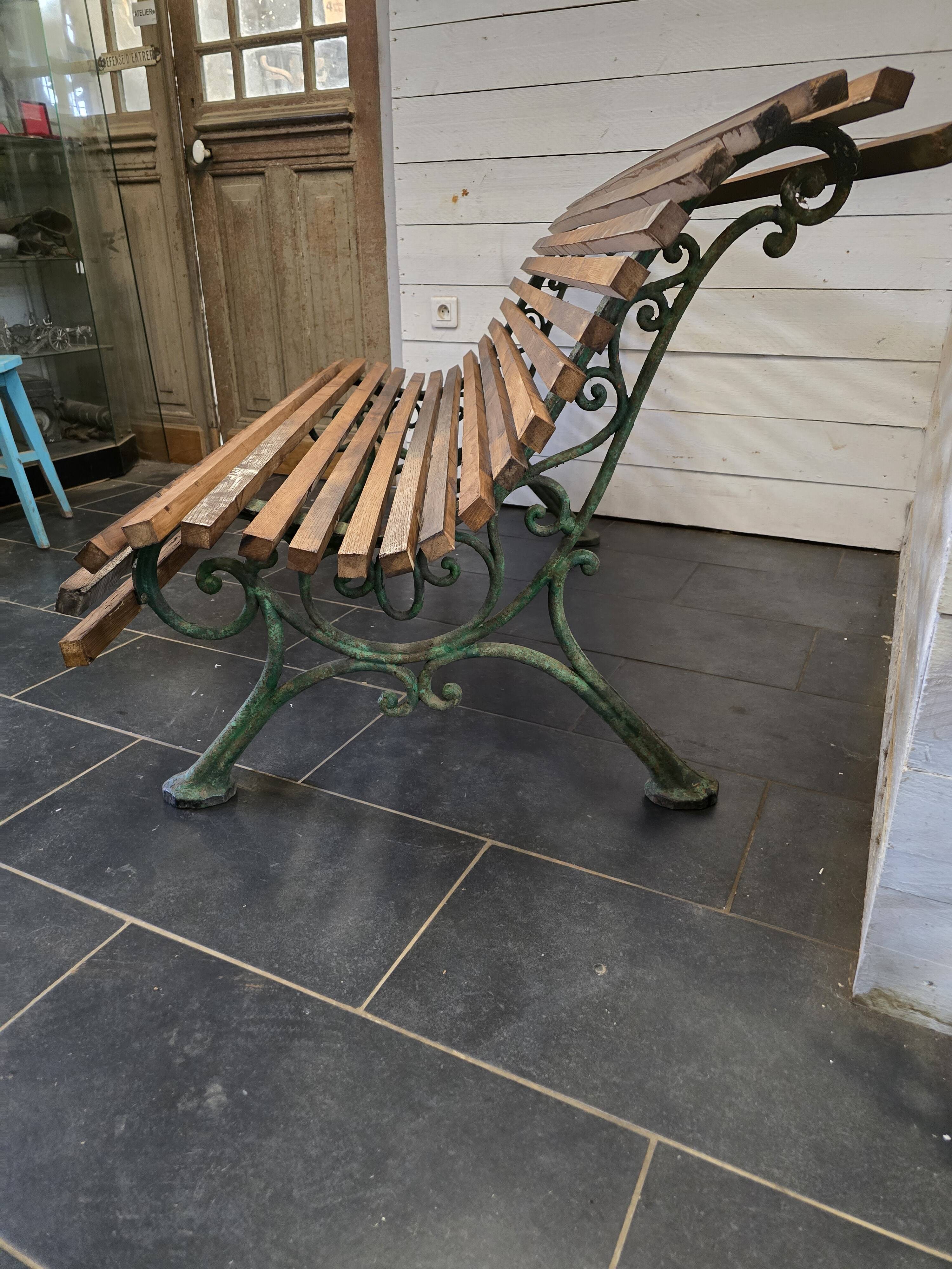 Old cast iron garden bench with oak slats