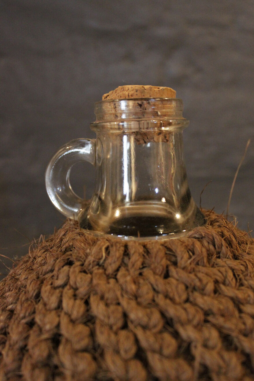Cylinder glass surrounded by rope