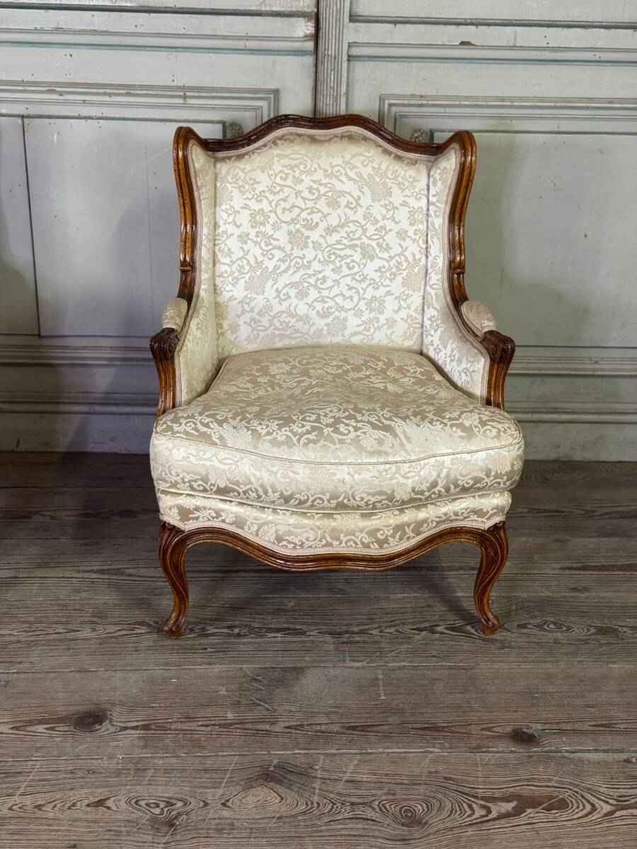 Pair of small Louis XV style wing chairs in carved walnut, Bosson stamp