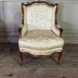 Pair of small Louis XV style wing chairs in carved walnut, Bosson stamp