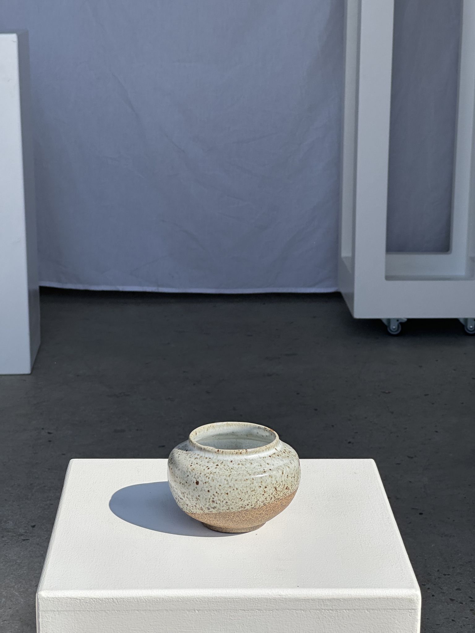 Small white ball vase tight neck in glazed speckled ceramic