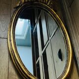 Old oval gilded stucco mirror