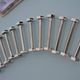 12 bolt-shaped knife rests in their original vintage box
