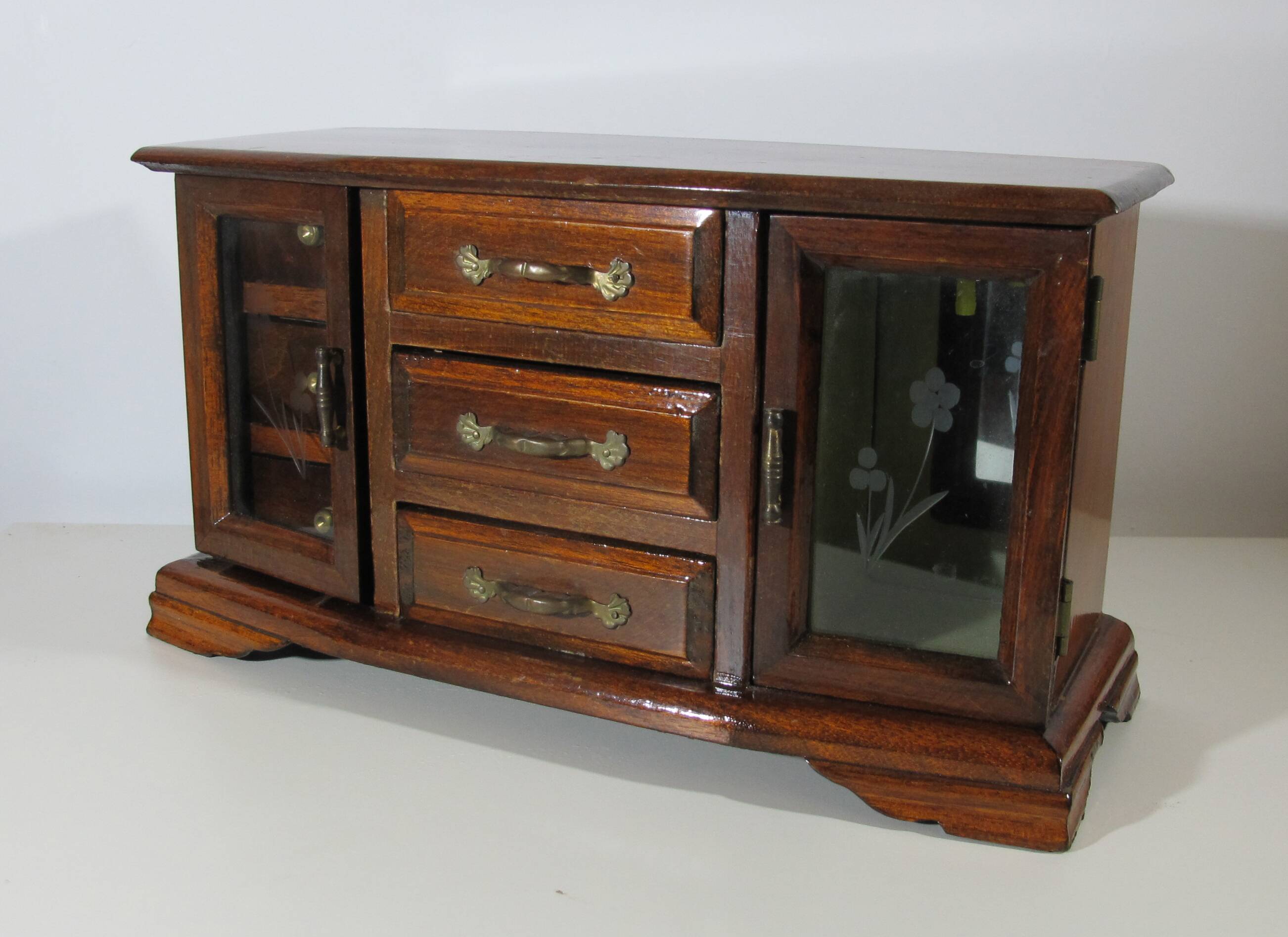 Wooden jewelry box in the shape of a dresser