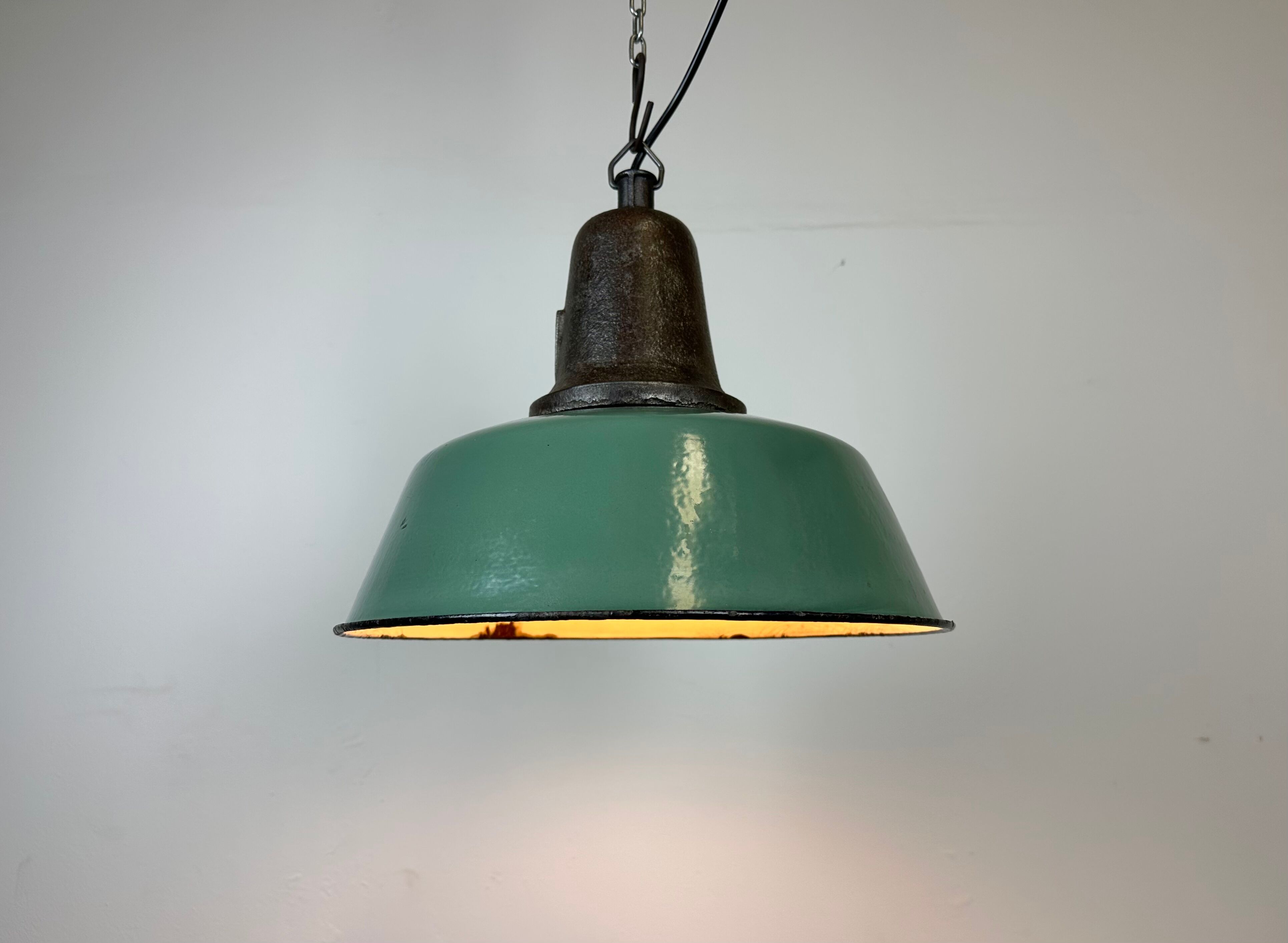 Industrial green enamel factory lamp with cast iron top, 1960s