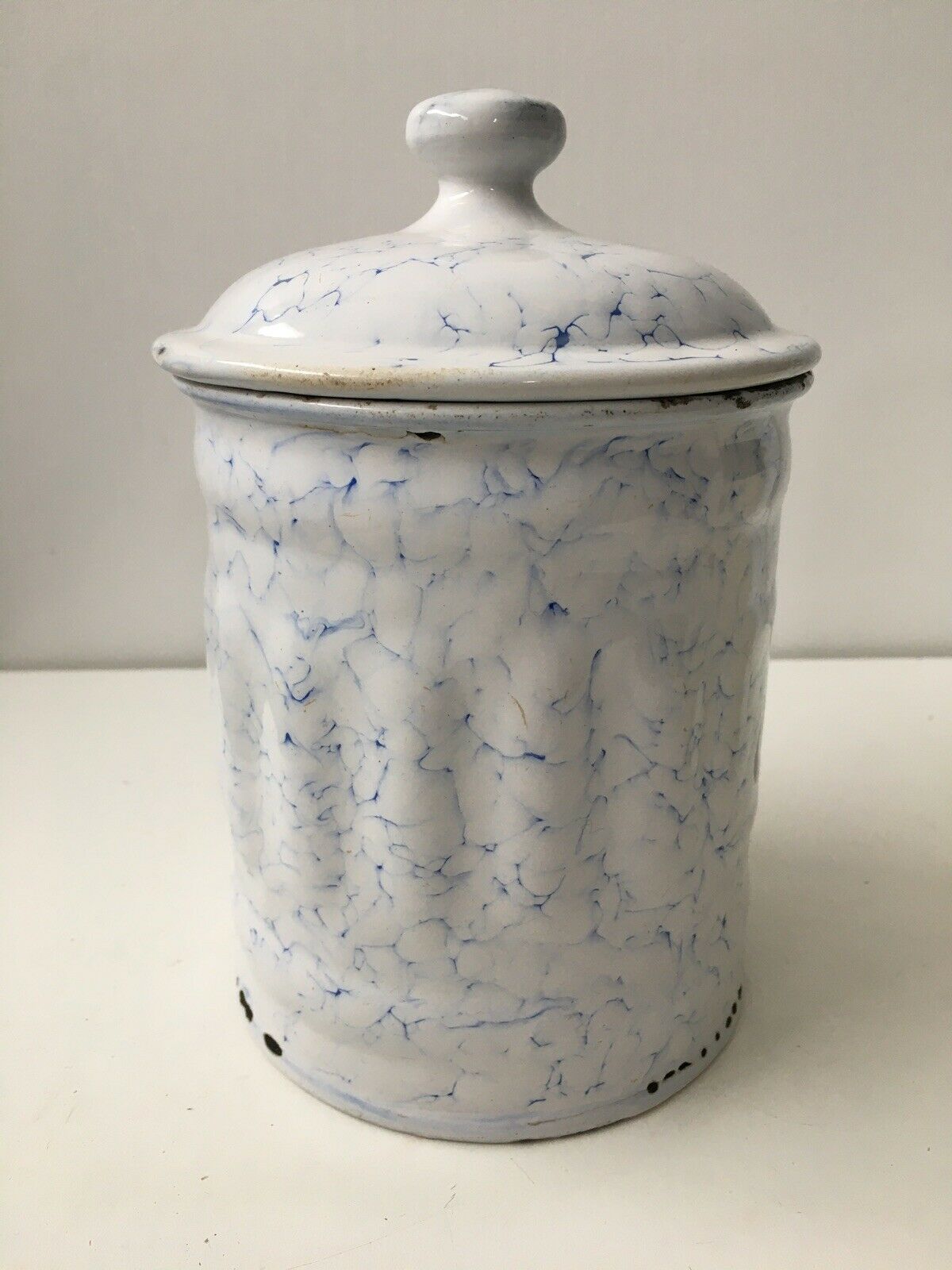 Vintage coffee pot in white enamelled iron and blue retro kitchen decoration