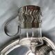 6 small glasses in their silver metal holder, with handle