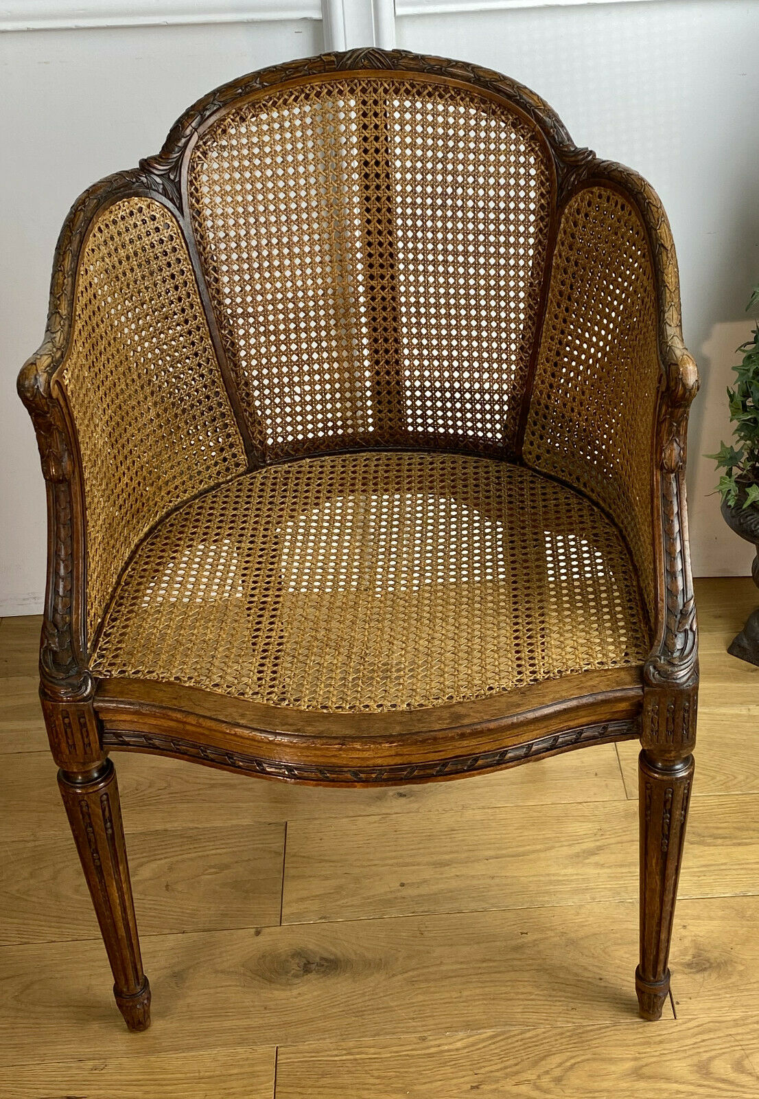 Old armchair with double cannage in walnut carved style Louis XVI of the nineteenth century