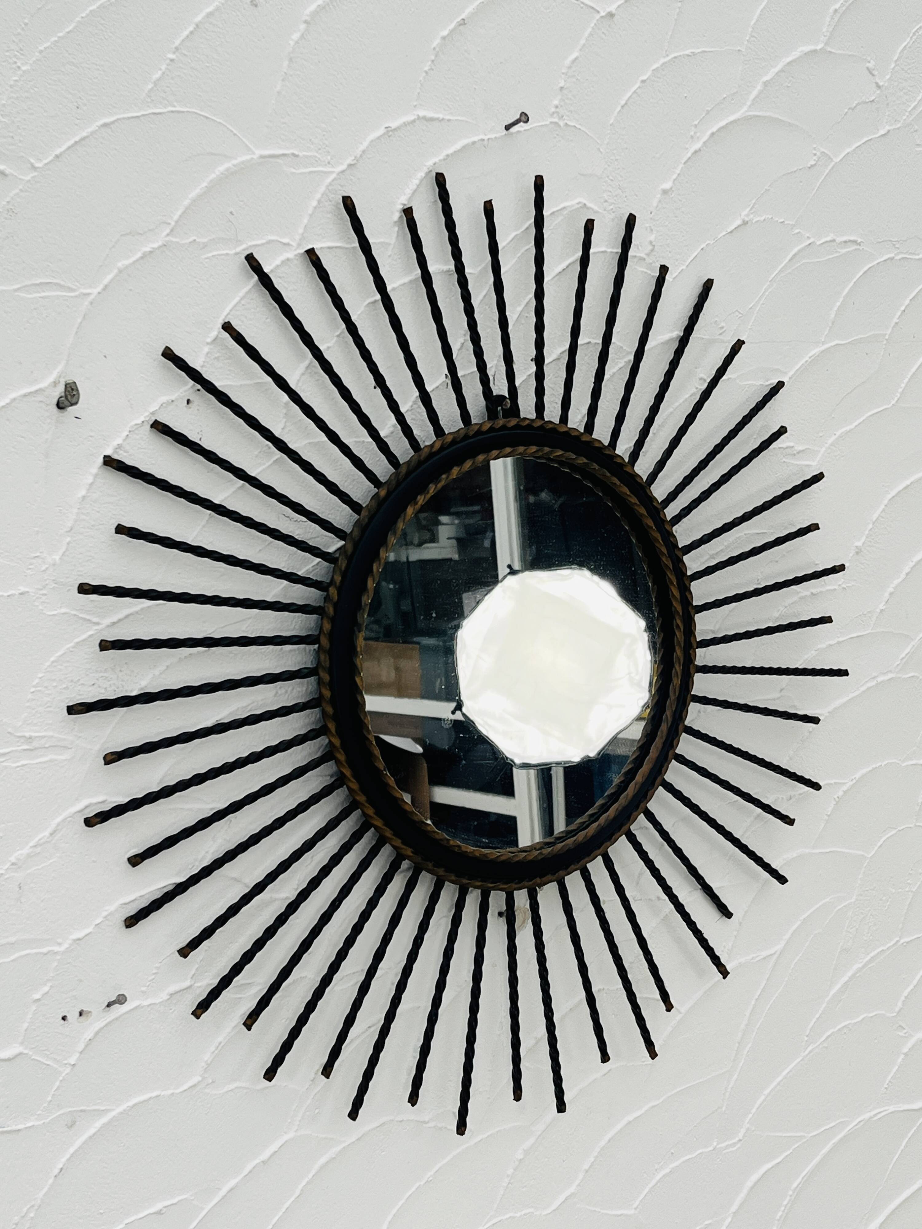 Vintage black and gold metal sun mirror from the 1960s.