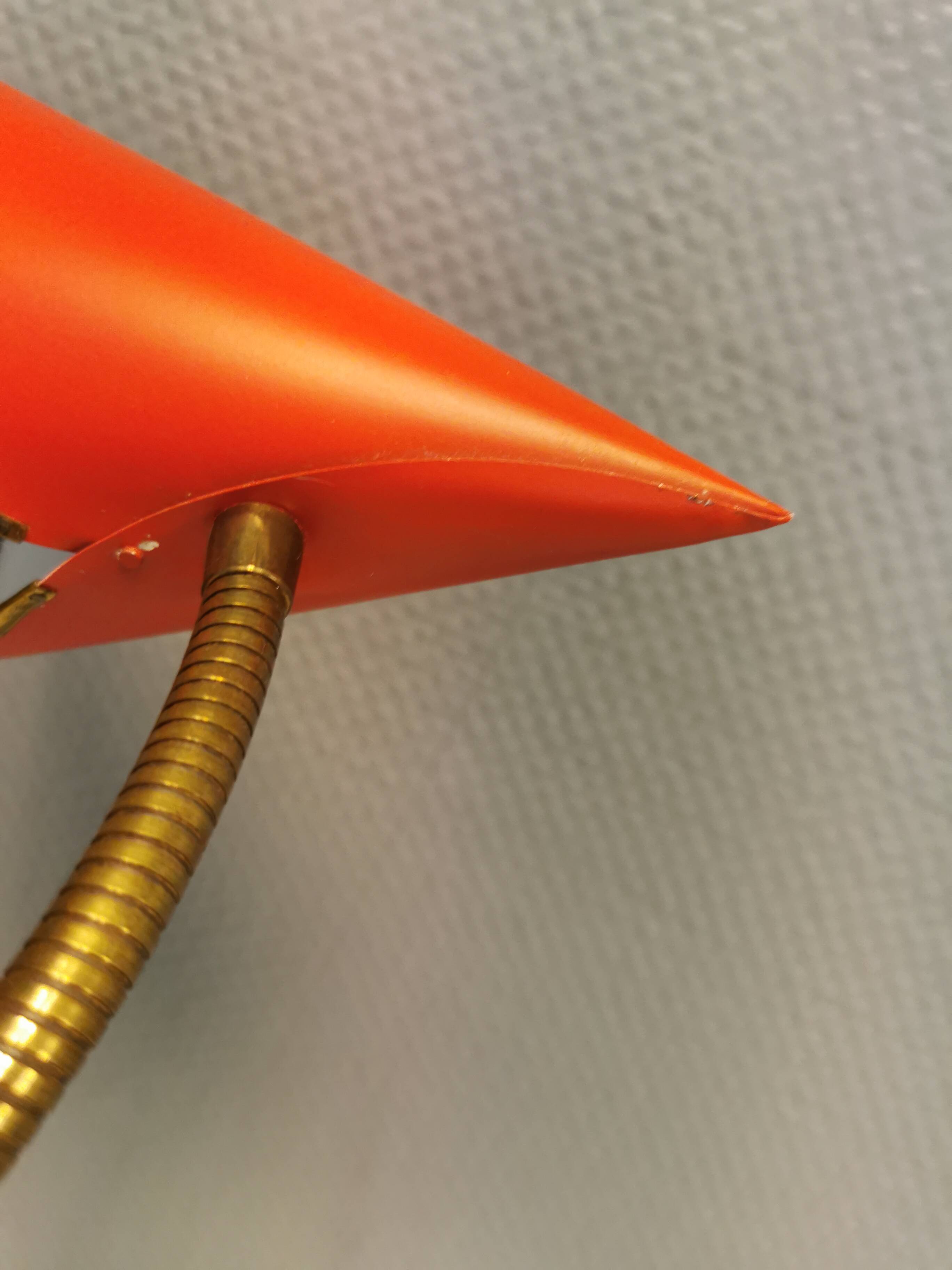 Danish red lacquered wall light with brass details. Estimated 1980s