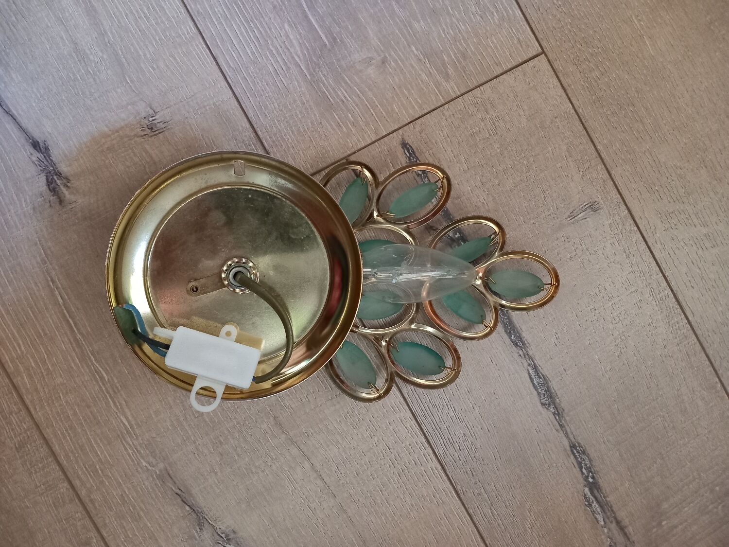 Gold metal wall light with light blue tassels