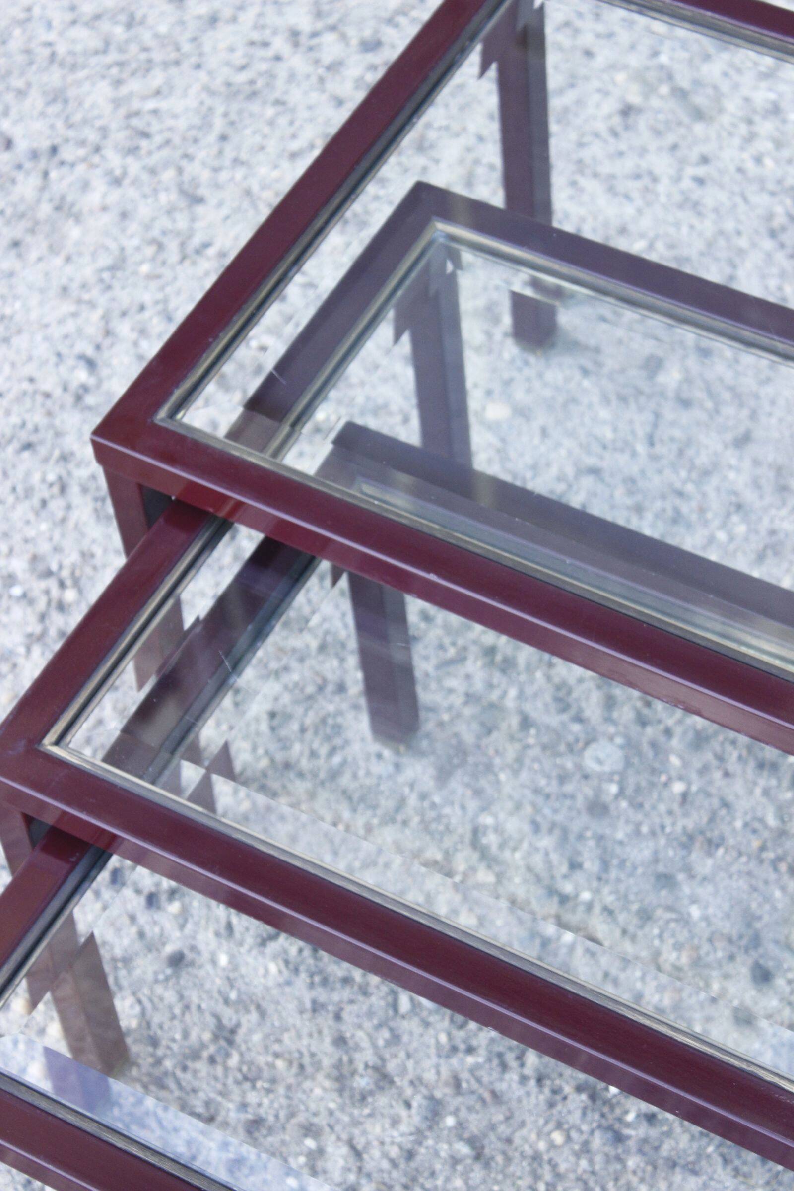 Nesting tables in burgundy lacquered metal and brass, France 1950s