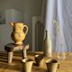 Large antique handmade ochre yellow jug with a pink flower pattern.
