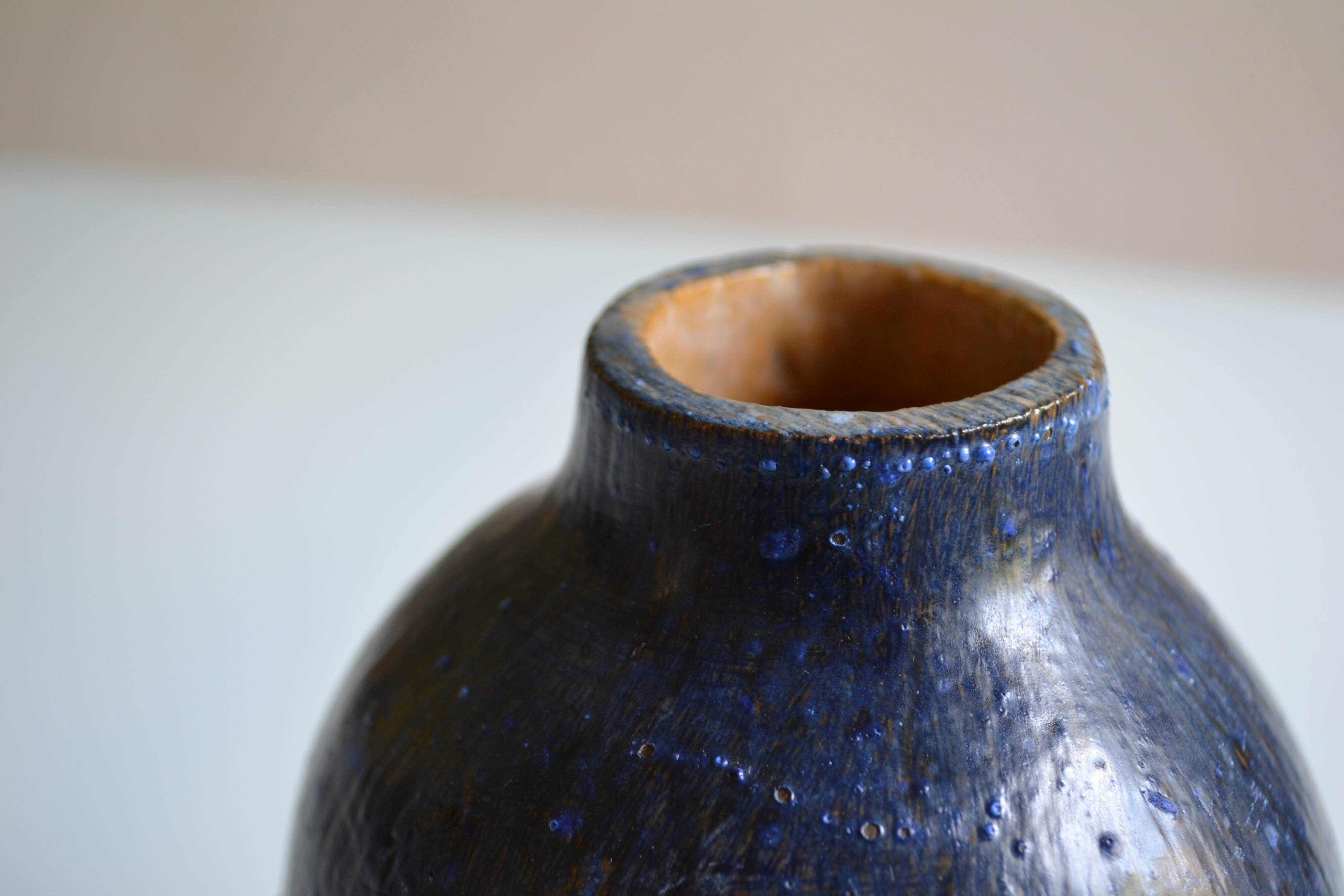 Ceramic bottle vase with a fish signature to be identified.